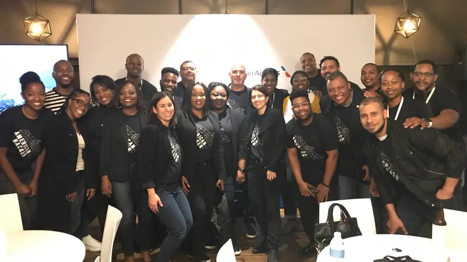 Group photo with Tre Stewart and American Airlines teammates after a workshop